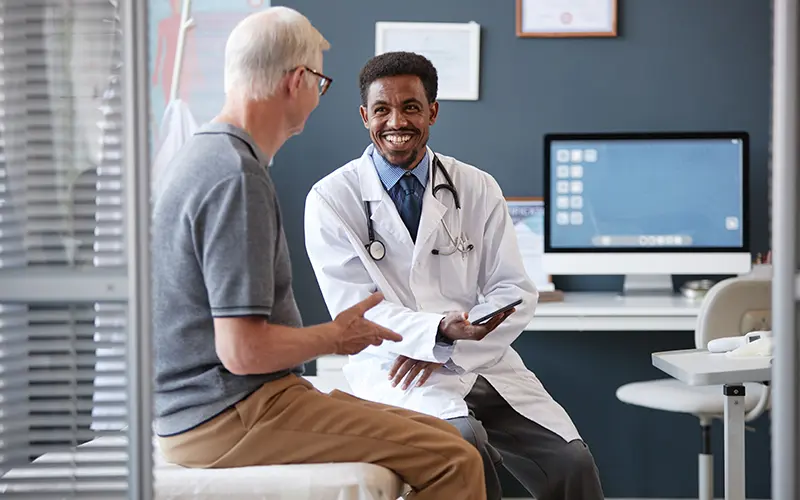 elderly man consulting his physician